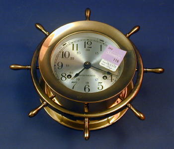 A BRASS CASED SHIPS CLOCK. With wheel decoration, labeled "Helmsman", Seth Thomas. — Antique Clocks Price Guide