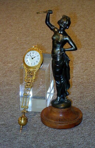 A CONTINENTAL PATINATED METAL FIGURAL 'SWINGER' CLOCK, — Antique Clocks Price Guide