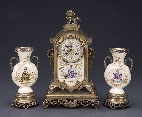 AN AESTHETIC MOVEMENT POLYCHROME-GILT BRONZE MOUNTED ENGLISH POTTERY CLOCK GARNITURE, Late 19th century, retailer's mark for J.E. Caldwell &amp; Co., Philadelphia, no. 10793. — Antique Clocks Price Guide