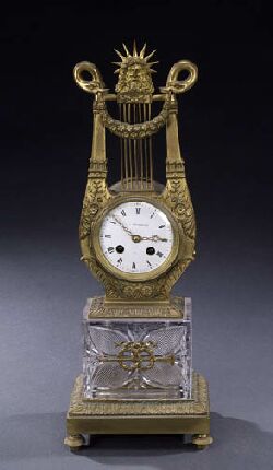A FRENCH EMPIRE STYLE GILT BRONZE AND GLASS MANTEL CLOCK, late 19th century. — Antique Clocks Price Guide