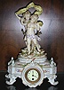 A FRENCH PORCELAIN FIGURAL MANTEL CLOCK, Late 19th/early 20th century, blue crossed lines mark for Samson.