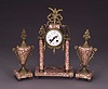 A FRENCH MARBLE AND ORMOLU CLOCK GARNITURE, Late 19th century.