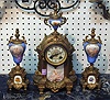 A FRENCH PORCELAIN CLOCK GARNITURE SET. Ormolu and porcelain, clock with two urns.