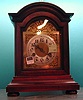 A GERMAN WALNUT CASED MANTLE CLOCK. Late 19th/early 20th c.