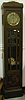A GERMAN ART NOUVEAU OAK TALL CASE CLOCK.