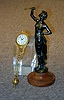 A CONTINENTAL PATINATED METAL FIGURAL 'SWINGER' CLOCK,