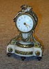 A LOUIS XVI STYLE GILT BRONZE AND ALABASTER SMALL MANTEL CLOCK,