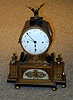 A FRENCH EMPIRE STYLE GILT BRONZE MOUNTED MANTEL CLOCK,