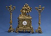 A CHARLES X STYLE GILT BRONZE ASSEMBLED CLOCK GARNITURE. mid-19th century.