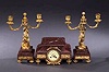 A FRENCH GILT BRONZE AND ROUGE MARBLE THREE-PIECE MANTEL GARNITURE, late 19th century.
