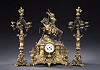 A FRENCH PATINATED AND PARCEL GILT BRONZE AND ONYX THREE-PIECE CLOCK GARNITURE, late 19th century.