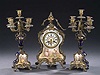 A FRENCH GILT METAL-MOUNTED THREE-PIECE CLOCK GARNITURE, movement by Japy & Cie, late 19th century.