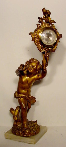 Full figural bronze cherub — Antique Clocks Price Guide