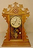 Welch oak & mixed wood parlor clock.