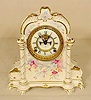 Ansonia Royal Bonn floral china case clock: open escapement. 
