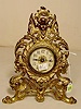 Figural cherub & man/dragon metal desk clock: 