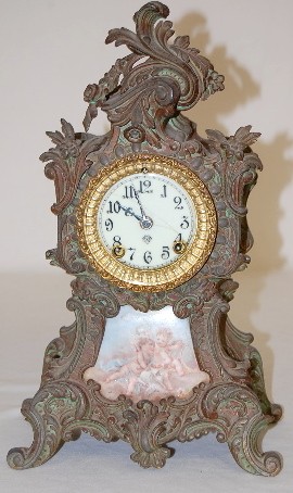 Ansonia Metal Clock w/Cherubs Porcelain Insert — Antique Clocks Price Guide
