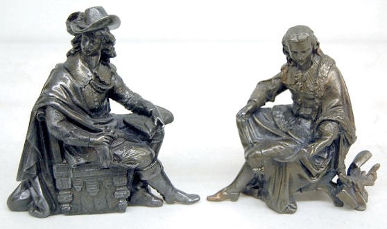 2 Clock Statues: Musketeer and Seated Man — Antique Clocks Price Guide