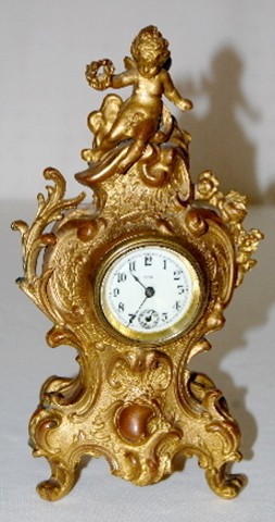 Metal Novelty Figural Cherub Dresser Clock — Antique Clocks Price Guide