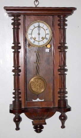 Carved RA Wall Hanging Clock — Antique Clocks Price Guide